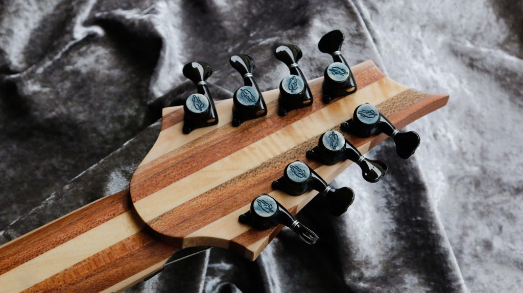chitarra kapooya 8 corde fanned body in mogano top in acero fiammato con resina luminescente effetto lichtenberg colore blu foto retro paletta con manico laminato